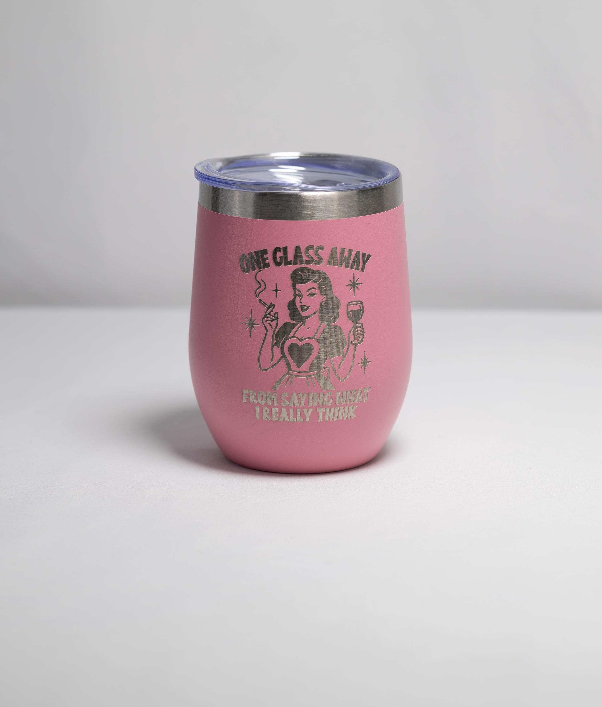 A pink thermos with a printed design on it, featuring a woman with a cigarette and the text "One glass away" along with the phrase "FROM RAISING THOUGH I REALLY THINK".