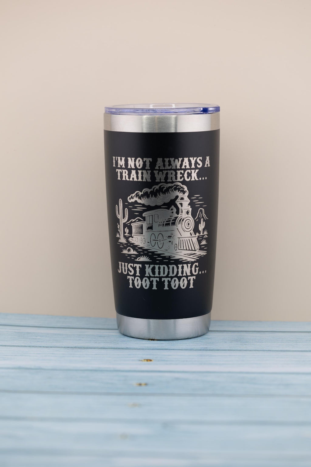 A black tumbler with a silver lid, featuring a humorous text and graphic design on its surface.