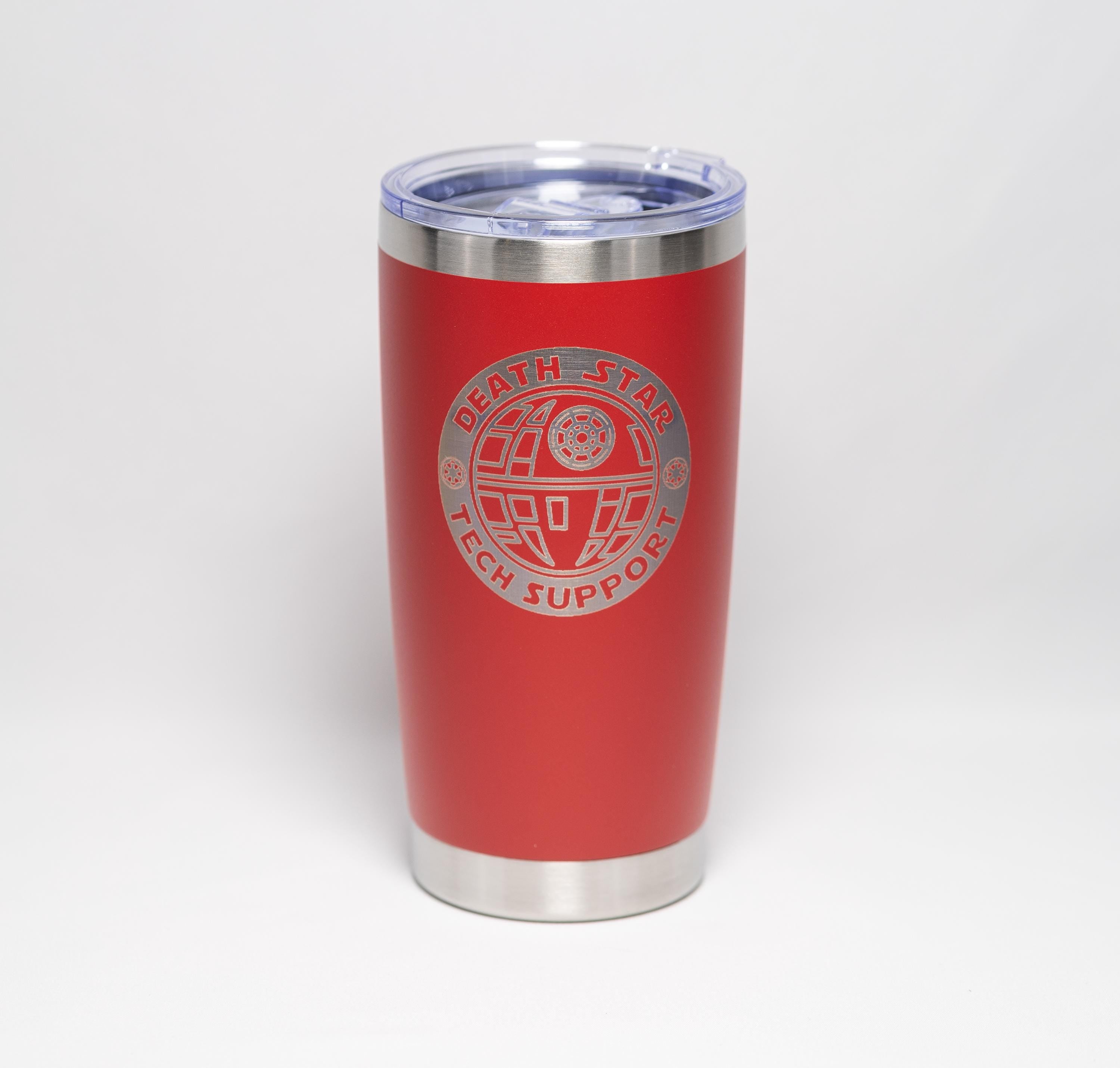 May include: A red insulated tumbler with a silver rim and lid. The tumbler features a silver graphic of the Death Star with the words "DEATH STAR TECH SUPPORT" in a circular design. The tumbler is approximately 7 inches tall.