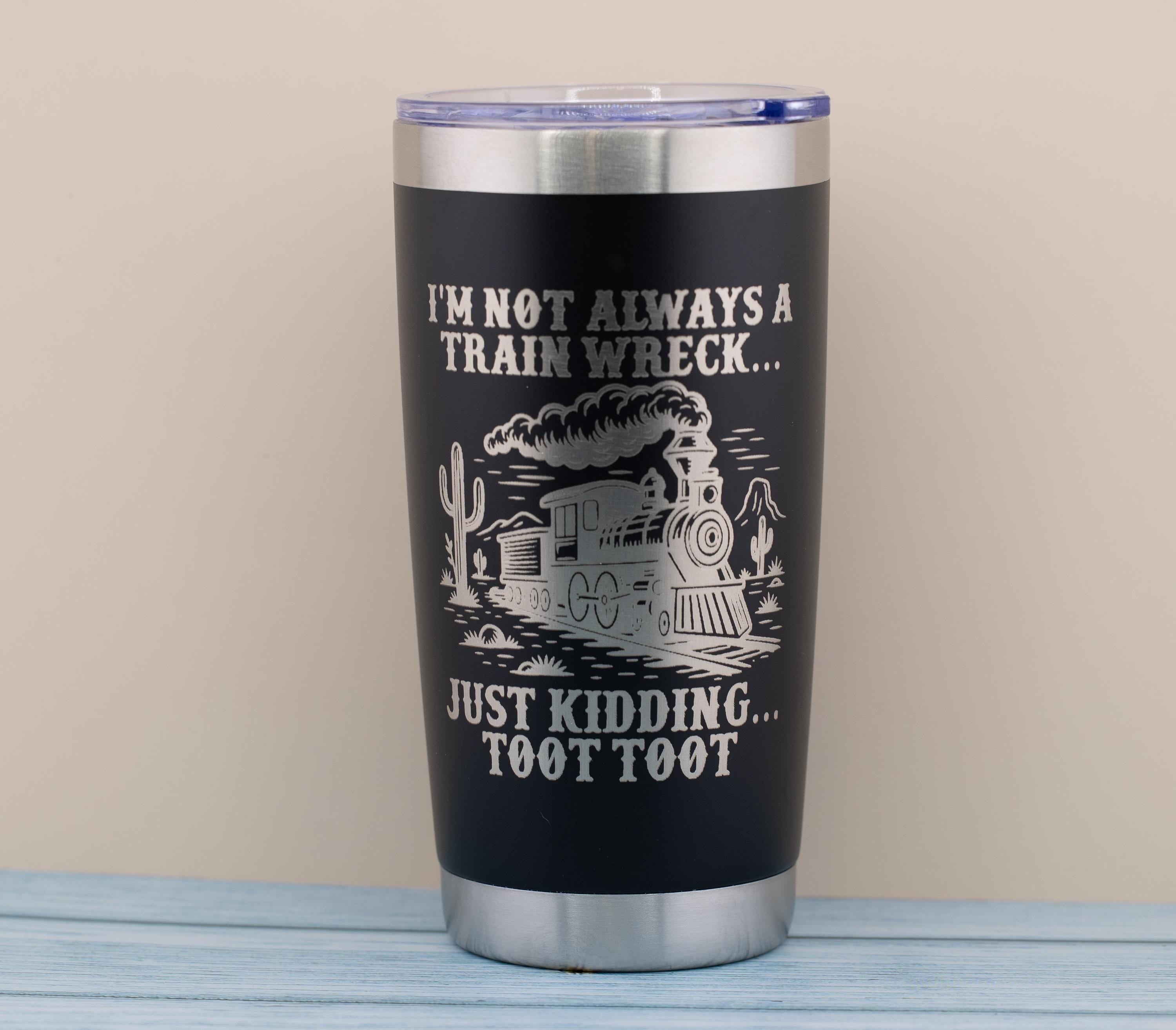 A black tumbler with a silver lid, featuring a humorous text and graphic design on its surface.