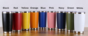 A row of colorful stainless steel tumblers in black, red, yellow, orange, blue, pink, navy, green, and white, arranged on a wooden surface.